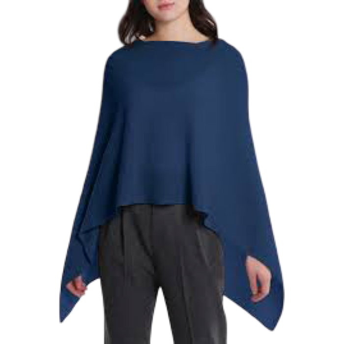 Woman wearing a blue poncho over a black outfit on a white background