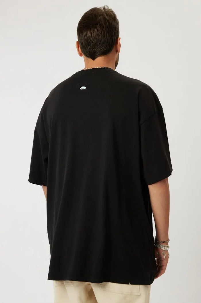 Back of a black Cotton T-Shirt with a small eye graphic on the neck