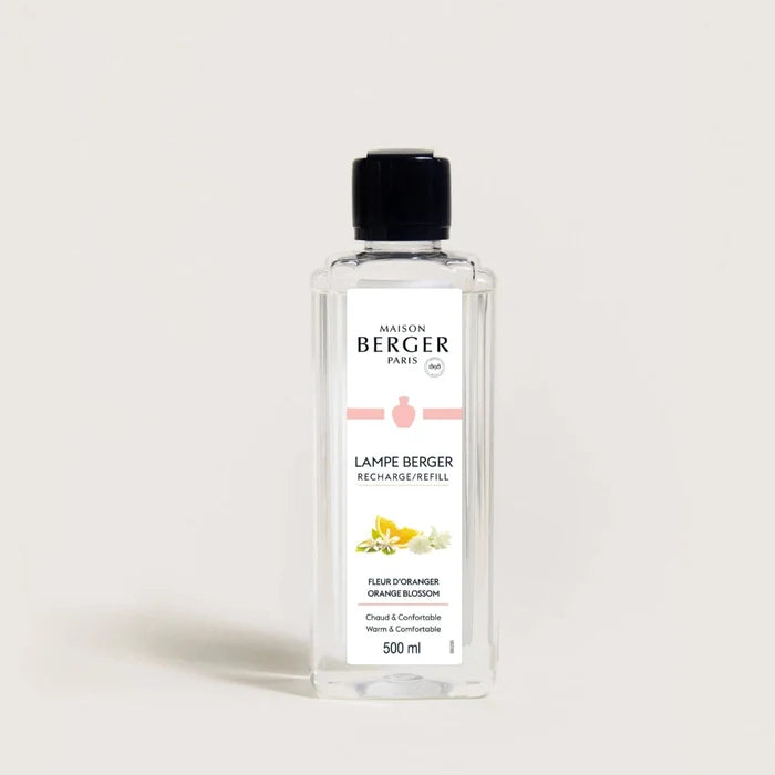 A clear bottle of Maison Berger fragrance diffuser refill with label, predominantly white label with orange and green text and accents.