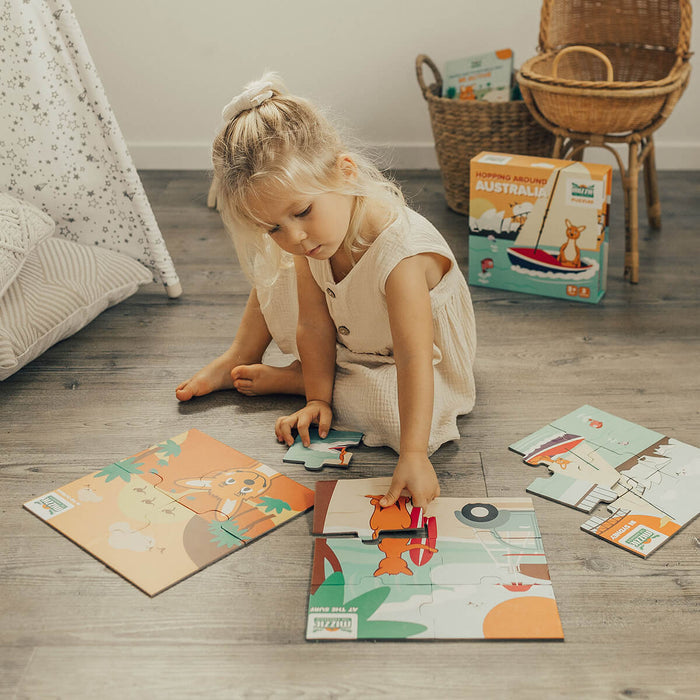 Child playing with Mizzie The Kangaroo Mizzie Puzzle Box Set, containing 3 puzzles with increasing difficulty levels (4, 6, and 9 pieces) featuring iconic Australian scenes. The set comes in a sturdy, sleekly designed magnetic box that keeps all the pieces neatly organised.