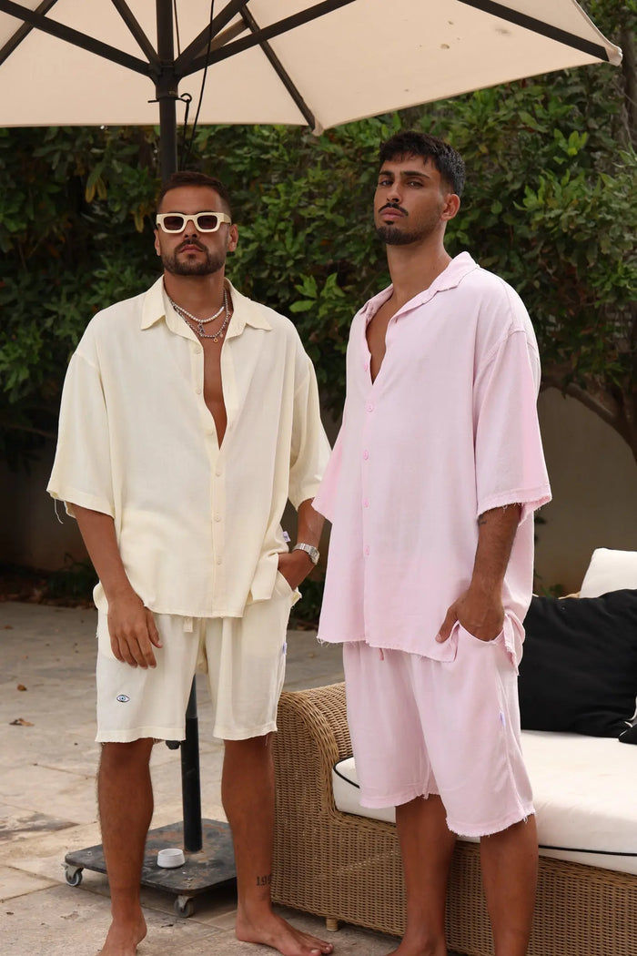 Two men wearing linen shirts and Soft Linen Bermuda Shorts in baby pink and cream