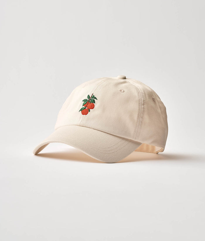 Beige cap with apple design on a light background