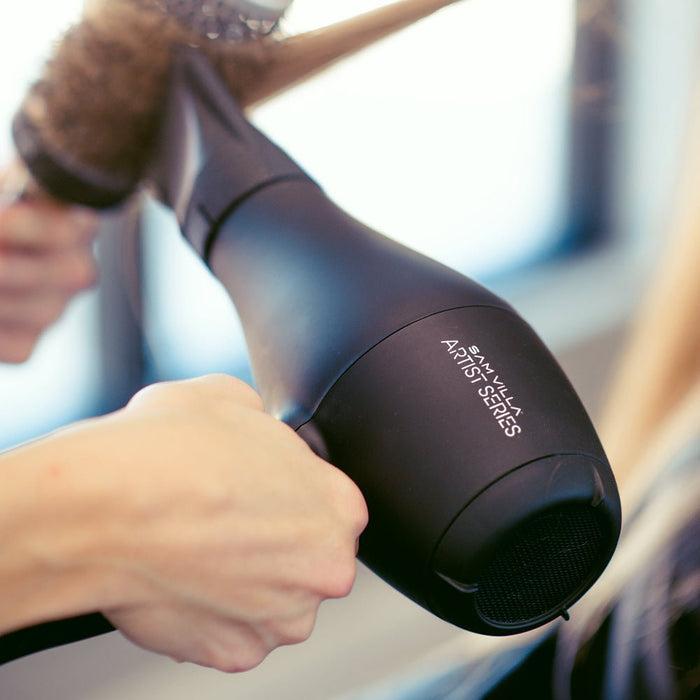 Stylist creating sleek, shiny hair with the Sam Villa Artist Series Professional Hair Dryer.
