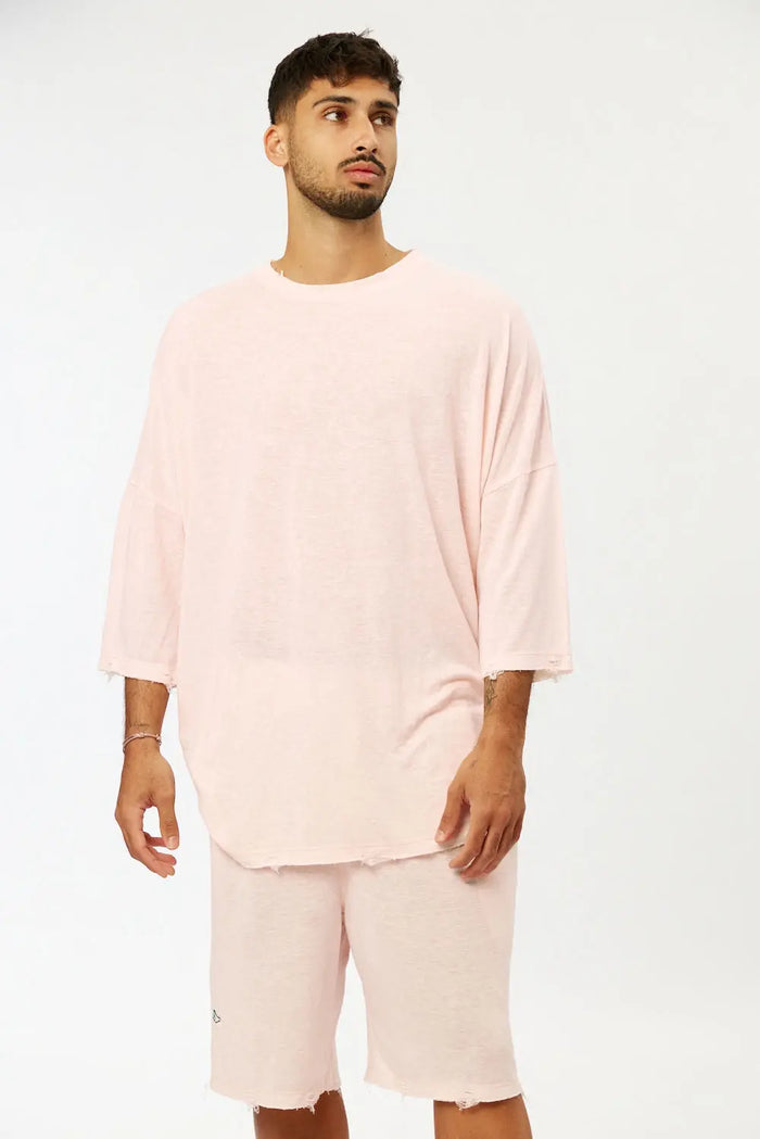 Man wearing Base Shorts in baby pink with matching oversized t-shirt
