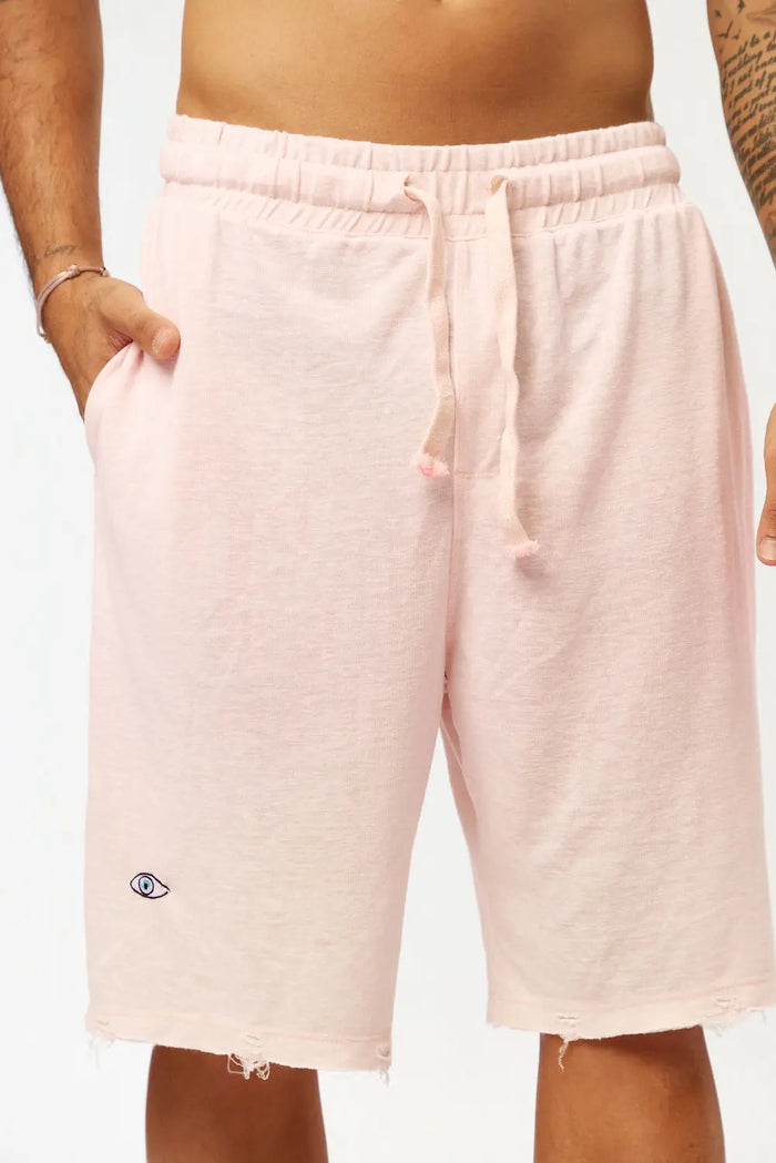 Base Shorts in baby pink with an eye logo and distressed hem