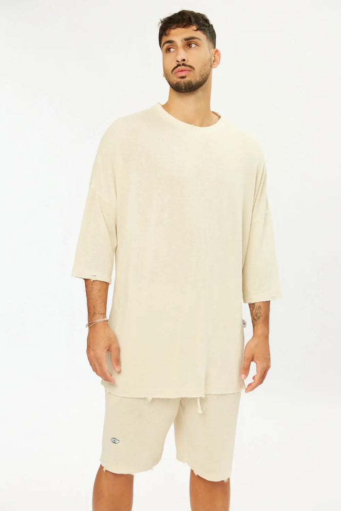 Man wearing Base Shorts in stone, with a matching oversized t-shirt