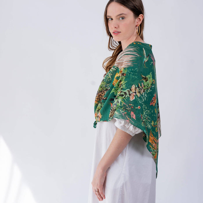 Woman wearing a green floral patterned scarf on a white background
