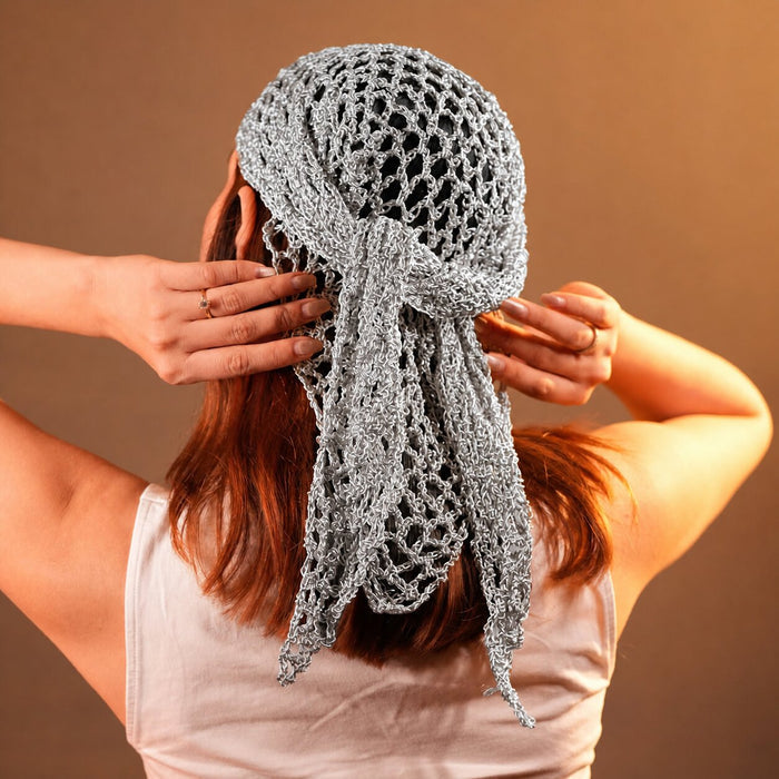 Off-white crochet headscarf with celestial charms, styled for summer days and festival looks.