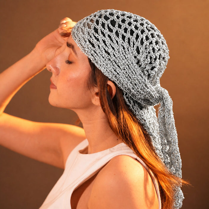 Bohemian off-white crochet bandana with moon, star, and coin charms for effortless styling.