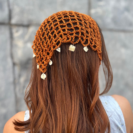 Brown crochet headscarf with shell charms in a small bohemian design for beach-ready styling