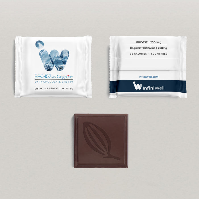 Flat lay of individually wrapped InfiniWell BPC with Cognizin dark chocolate cherry supplement beside an unwrapped chocolate square.