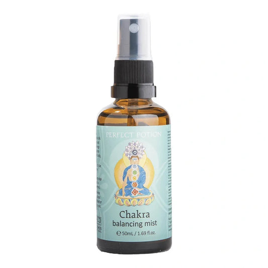 A 50 mL amber glass spray bottle of Perfect Potion Chakra Balancing Mist, featuring a light blue label with a seated deity illustration and a black spray nozzle.