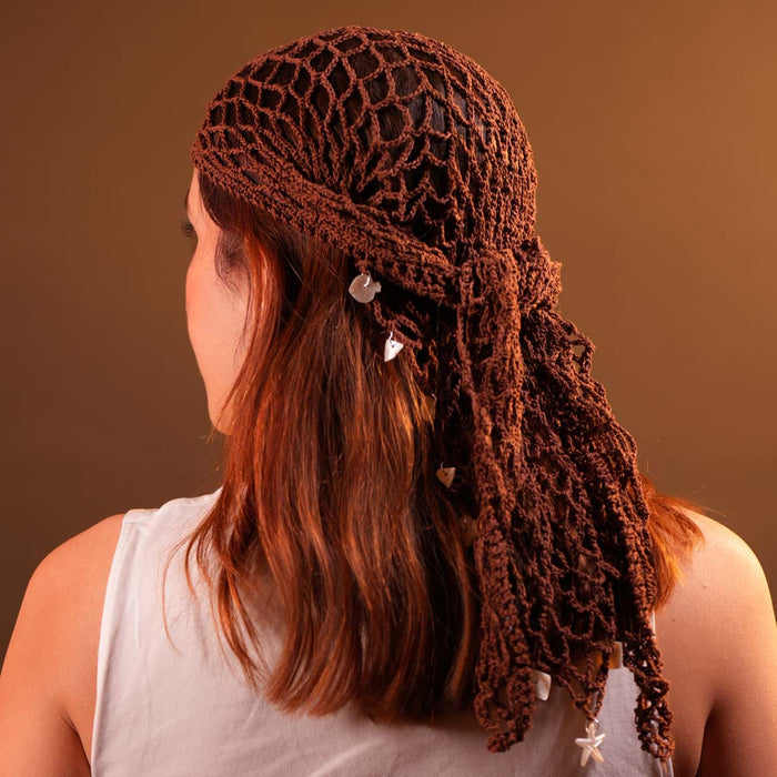 Brown crochet headscarf with shell charms styled as boho hair wrap for beach days