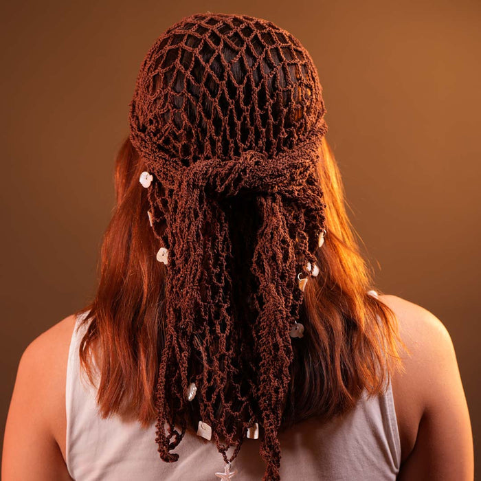 Bohemian brown crochet headscarf tied bandana-style with dangling shell details