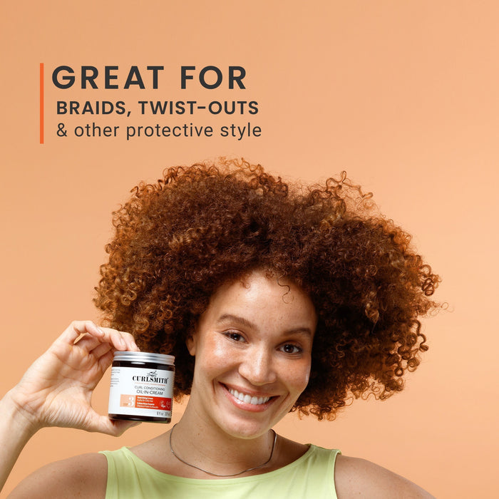 Woman with curly hair holding a jar of hair product against an orange background