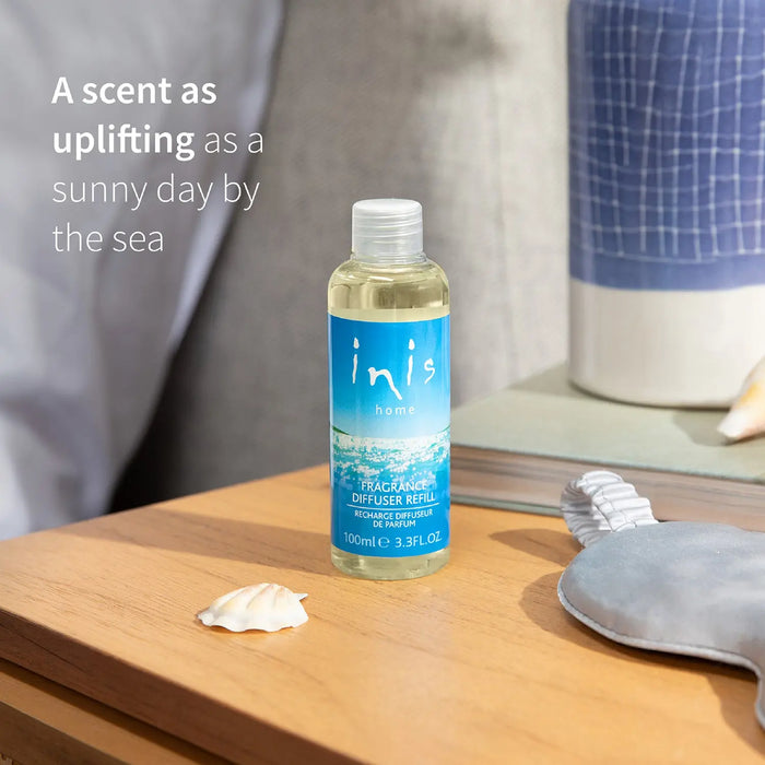Diffuser refill bottle on a wooden surface with text.