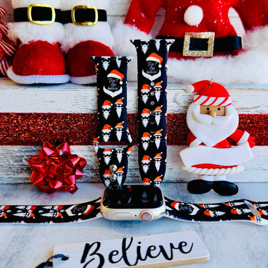 Don't Stop Believin' Apple Watch band with Santa beards and red hats on black background with Christmas decorations