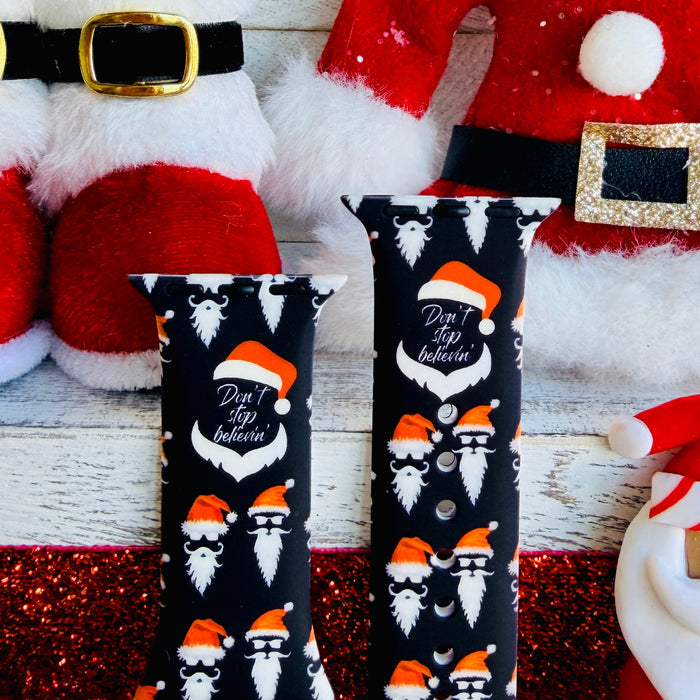 Don't Stop Believin' Apple Watch band with Santa beards and red hats on black background with Christmas decorations