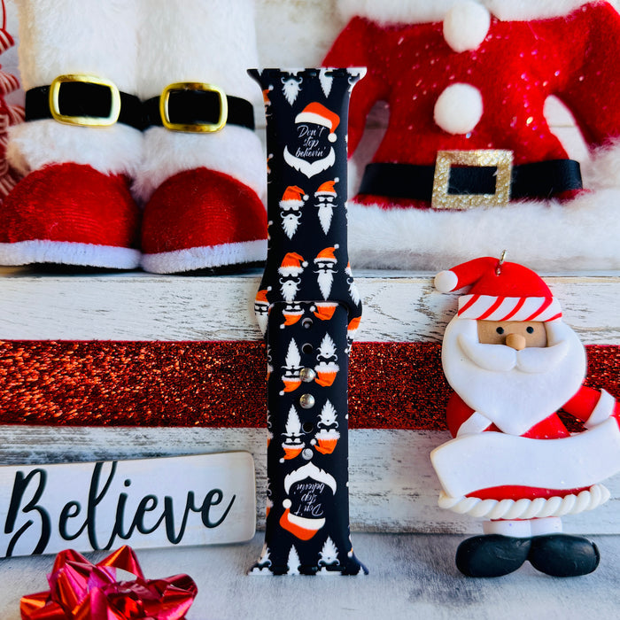 Don't Stop Believin' Apple Watch band with Santa beards and red hats on black background with Christmas decorations