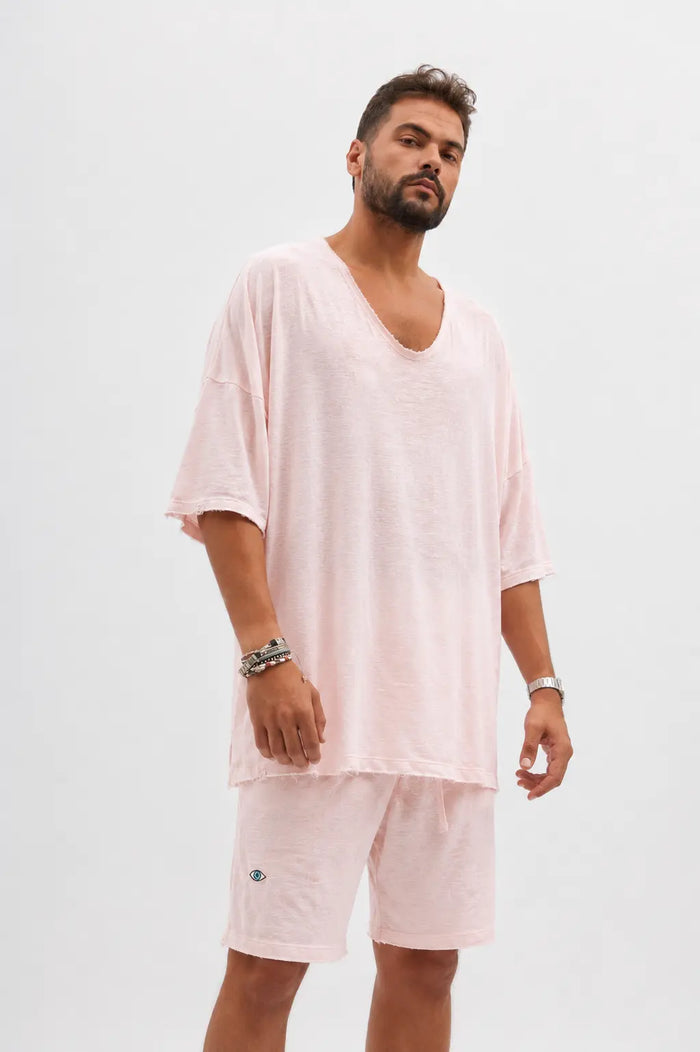 Dor Oversized Shirt in baby pink worn by a man with a beard, paired with matching shorts