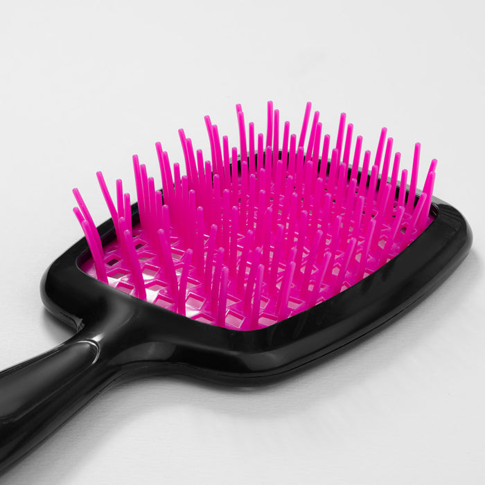 Black hairbrush with pink bristles on a white background