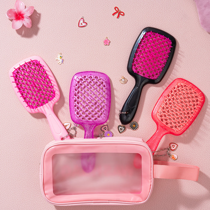 Four hairbrushes in pink, purple, and black with a pink carrying case on a light pink background.