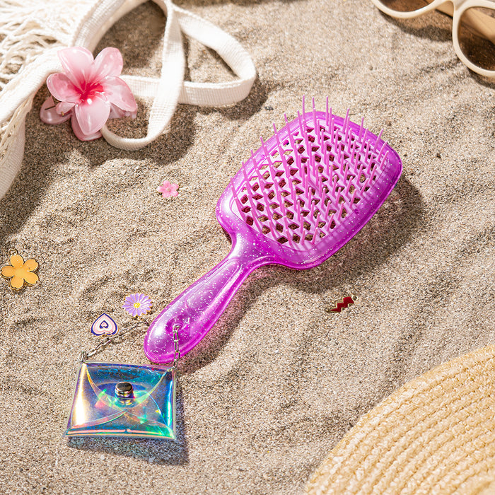 Purple hairbrush with heart patterns on a white background