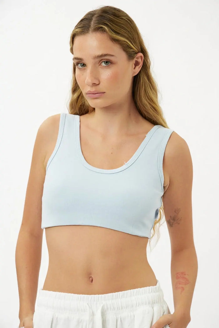 Essential Crop Top in light blue worn by a woman with long blonde hair