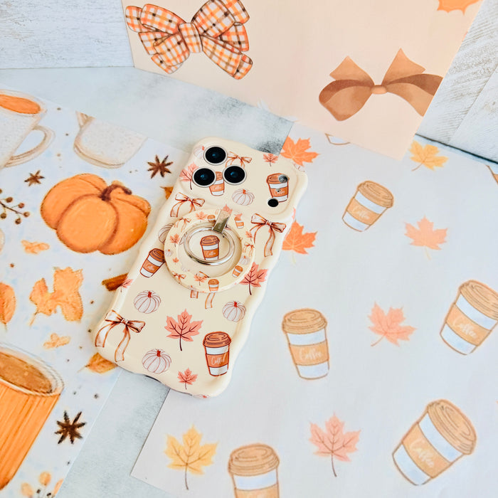 Falling in Love a Latte Wavy Luxe iPhone case with the matching MagSafe grip ring attached, styled on a latte and pumpkin print paper with a gingham bow.
