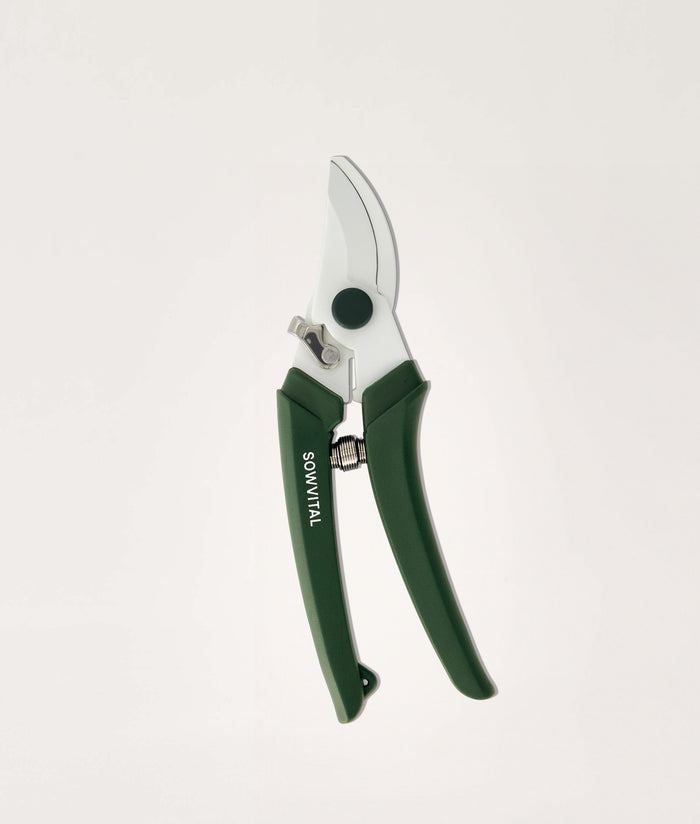 Gardening secateurs with green handles on a white background.
