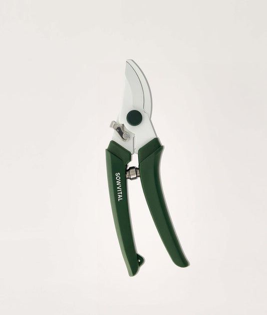 Gardening secateurs with green handles on a white background.
