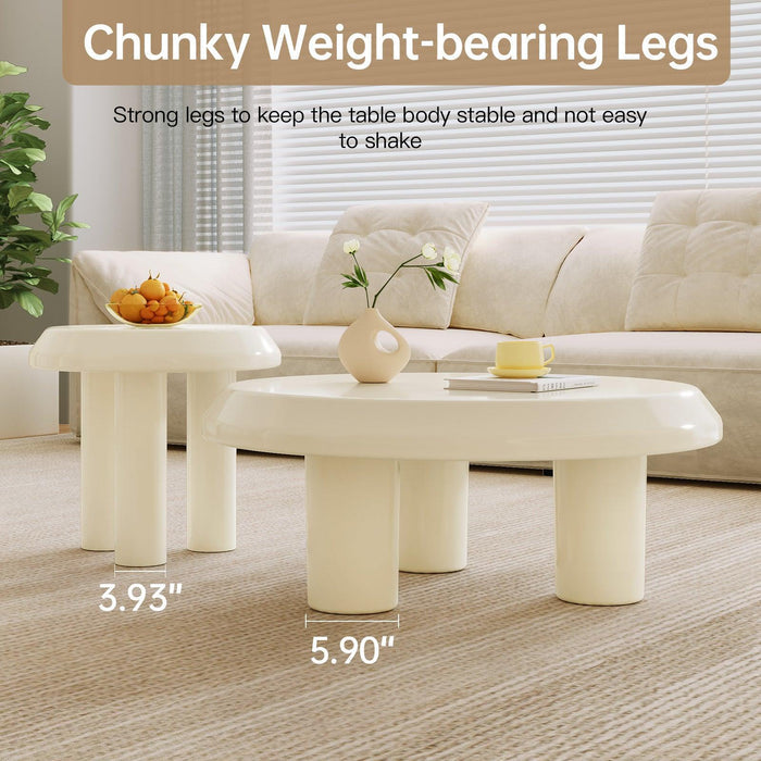 Large coffee table with robust tri-leg support paired with a compact side table.
