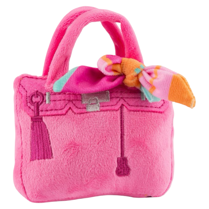 Pink plush handbag with a bow on a white background
