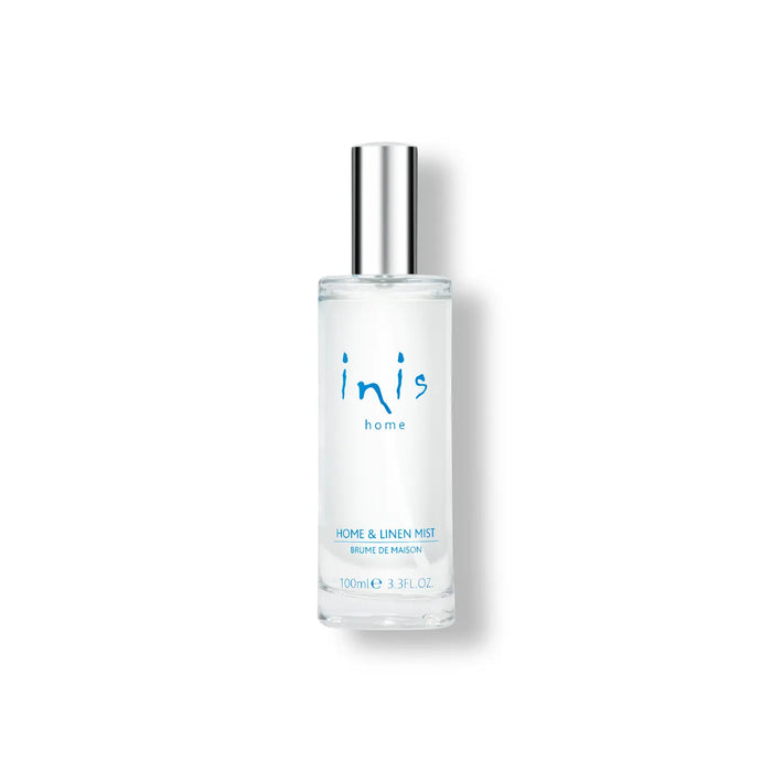 Clear glass bottle with silver cap labeled 'inis' on a white background
