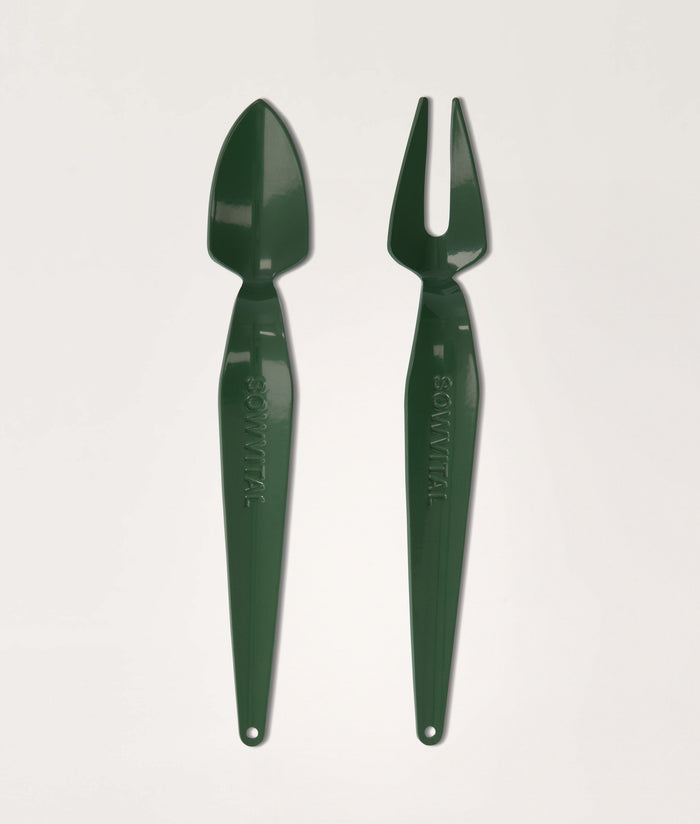 Green garden tool set with trowel and fork on a light gray background.