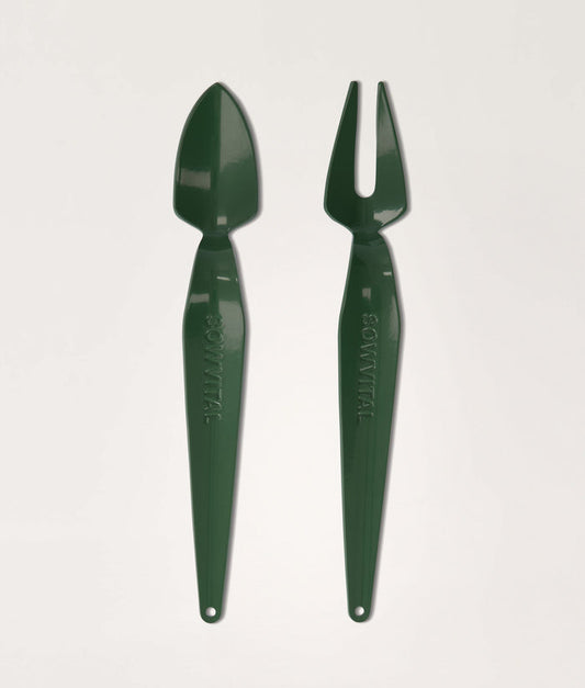 Green garden tool set with trowel and fork on a light gray background.