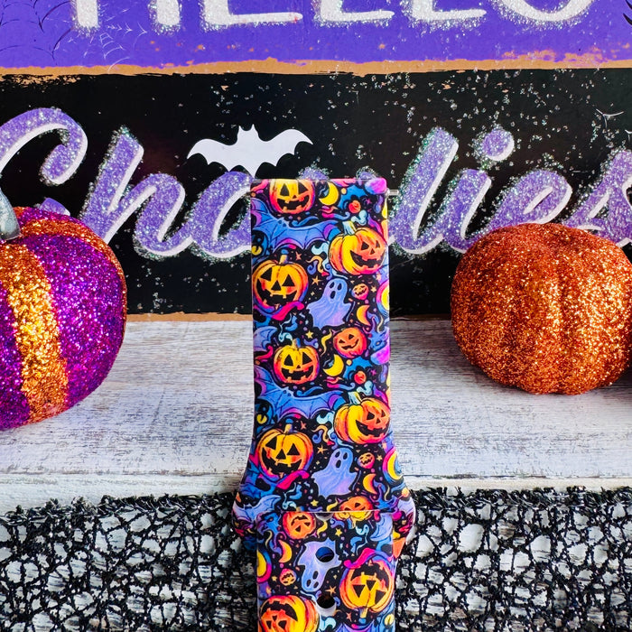 Jack-O-Lantern Jive Samsung Galaxy Watch band strap standing in front of a HELLO Ghoulies sign with an orange glitter pumpkin.