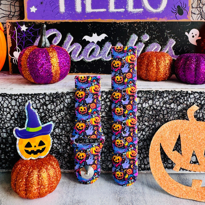 Close-up of two Jack-O-Lantern Jive Samsung Galaxy Watch band straps showing glowing pumpkins, lavender ghosts and crescent moons.