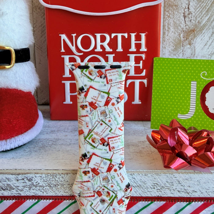 Close-up of Letters to Santa Christmas envelope print pattern on Apple Watch silicone band showing candy canes and stamps