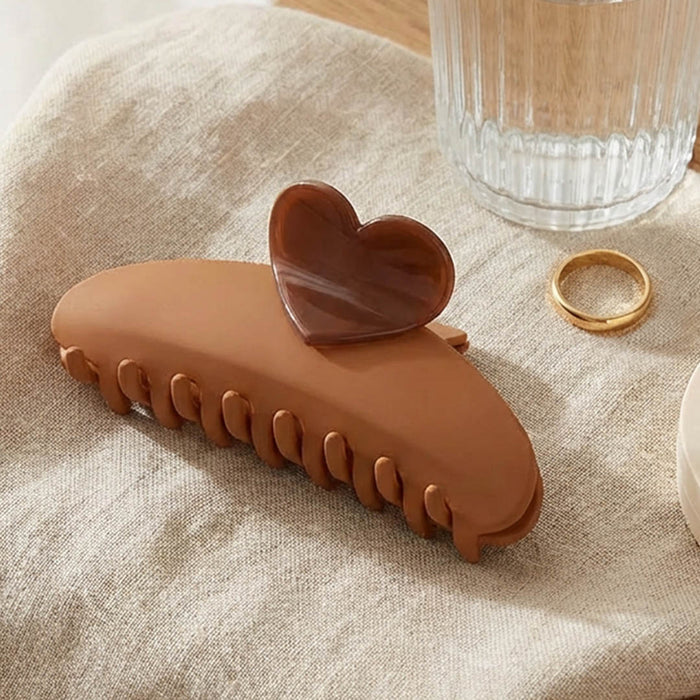 Chic brown claw clip with heart detail, perfect for effortless buns, twists and updos