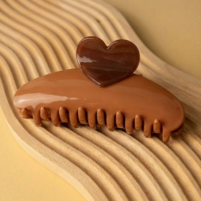 Elegant brown hair claw with heart accent that pairs beautifully with casual outfits