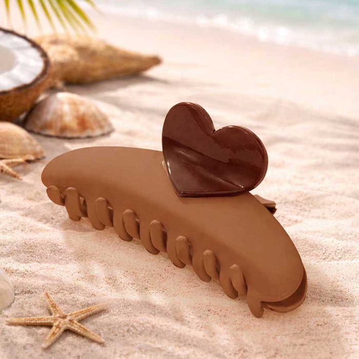 Heart-inspired brown claw clip offering a comfortable grip for everyday hair styling