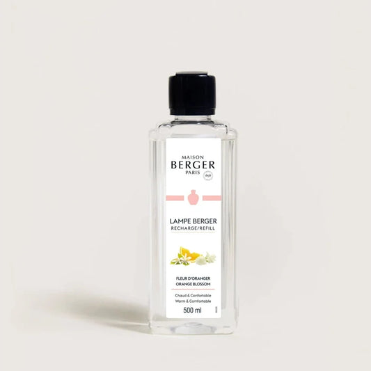 A clear bottle of Maison Berger fragrance diffuser refill with label, predominantly white label with orange and green text and accents.