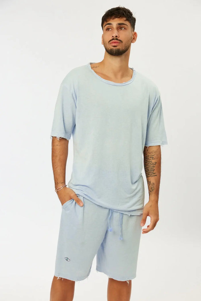 Man wearing Nicki Soft Open Top in Light Blue with matching shorts