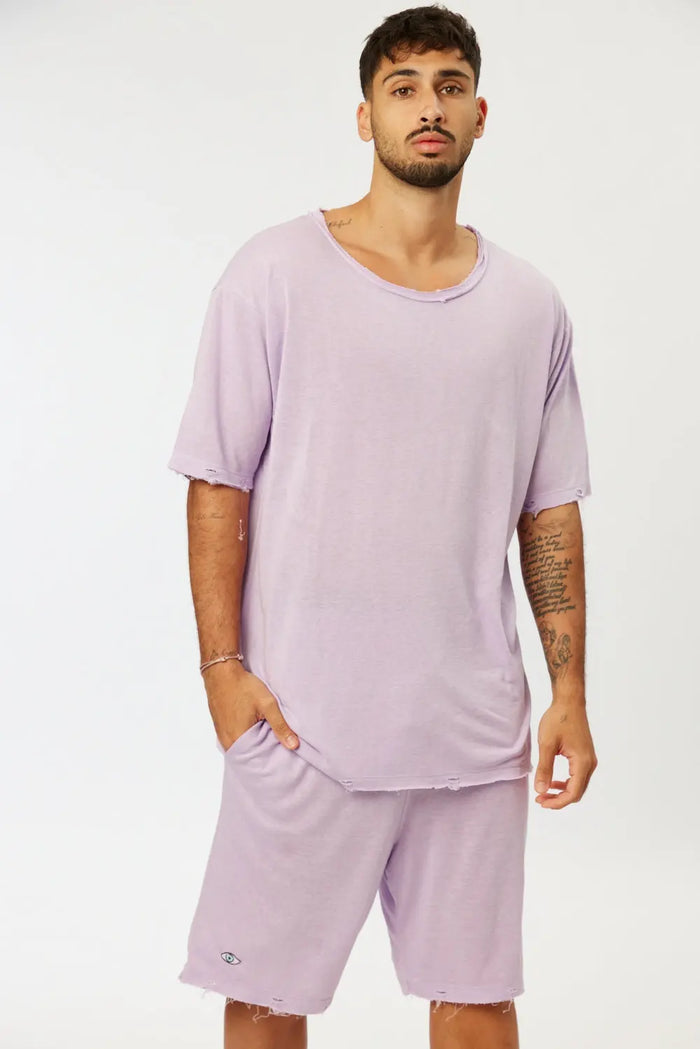 Man wearing Nicki Soft Open Top in purple with matching shorts