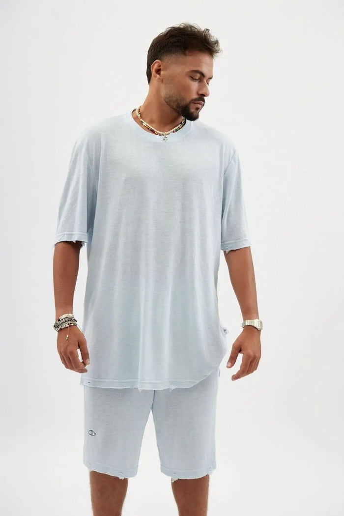 Man wearing a TFU Soft Essential Tee in sky blue with matching shorts and accessories