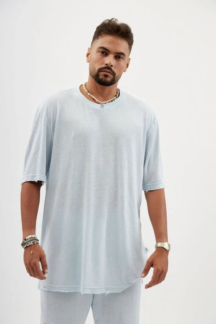 TFU Soft Essential Tee in sky blue worn by a man with a beard, necklaces, and bracelets
