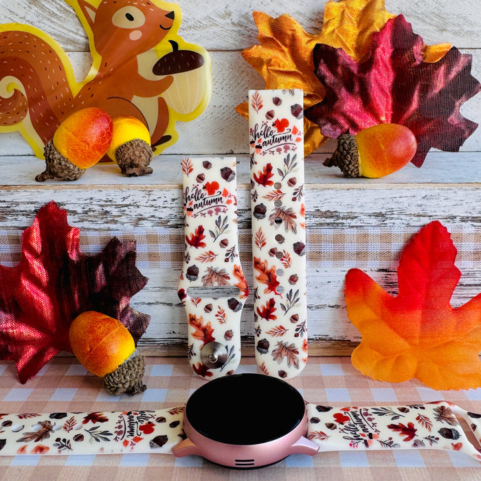 Nutty For Fall silicone Samsung Galaxy Watch band shown with a round Galaxy Watch, both strap halves standing upright to display the cream base with watercolor acorns, oak leaves, and hello autumn script.