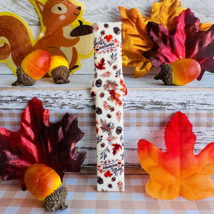 Close-up of the Nutty For Fall Samsung Galaxy Watch band showing the hand-lettered hello autumn script and the watercolor detail on each acorn cap.