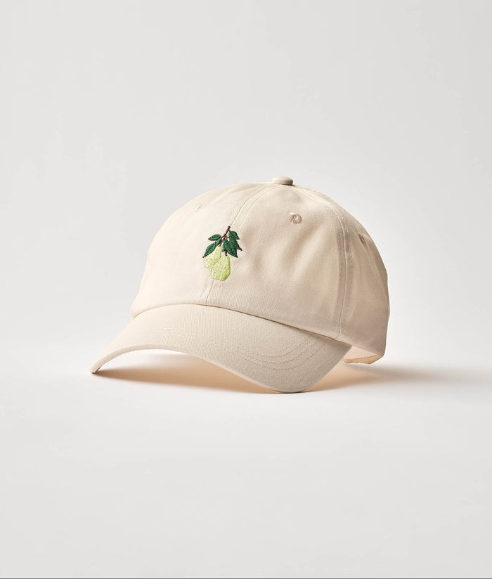 Beige cap with pear design on a light background.